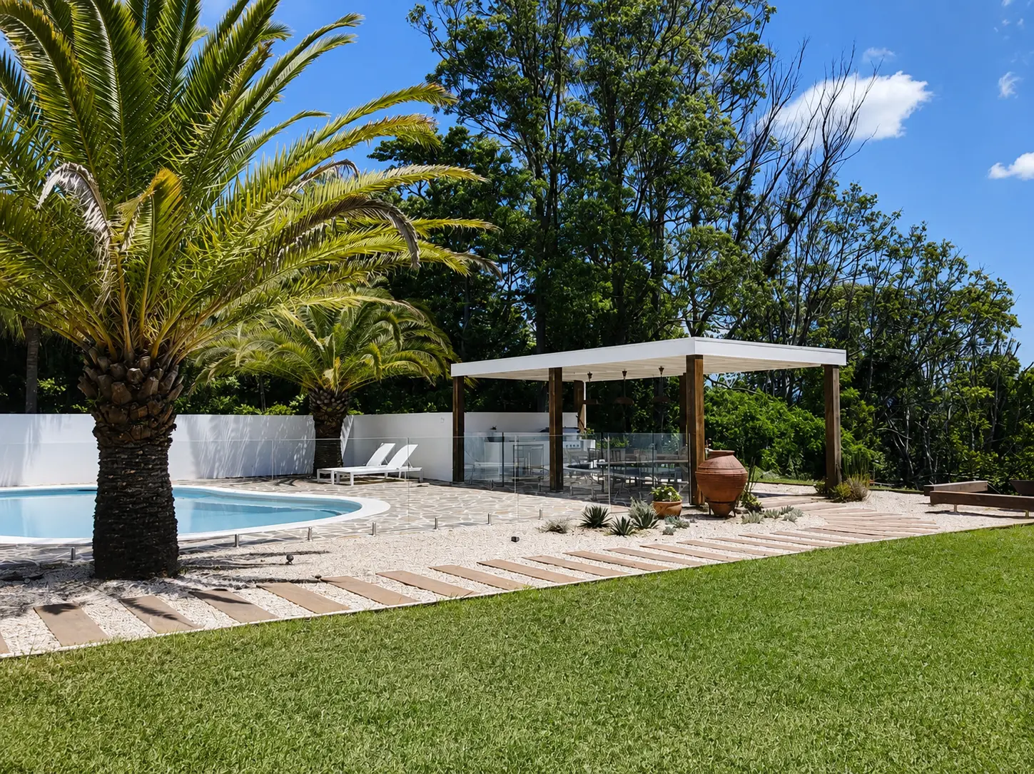 Clunes outdoor area renovation — dining pavilion and stone fireplace beside the pool